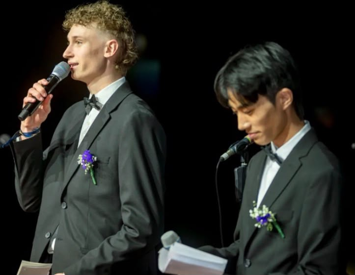 Shijie Zhong speaking at a formal student event